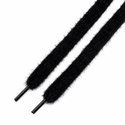 Black fuzzy shoelaces with black plastic aglets, shown diagonally on a plain white background.
