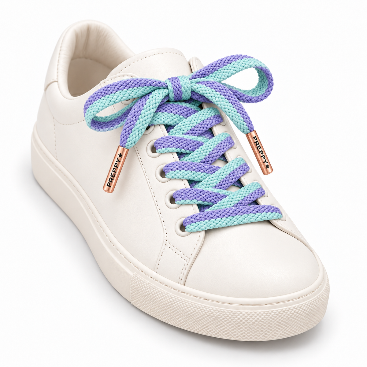 A white leather low-top sneaker with chunky braided laces in pastel purple and mint green, featuring rose gold metal eyelets with 'PREYX' branding.
