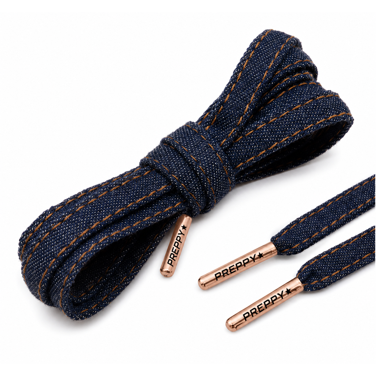 Dark blue denim shoelaces with brown contrast stitching and rose gold metal tips branded with 'PREPPY+'.